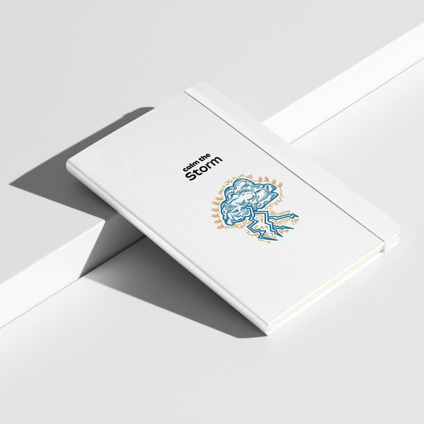 White notebook with "Calm the Storm" and an illustrated cloud with lightning.