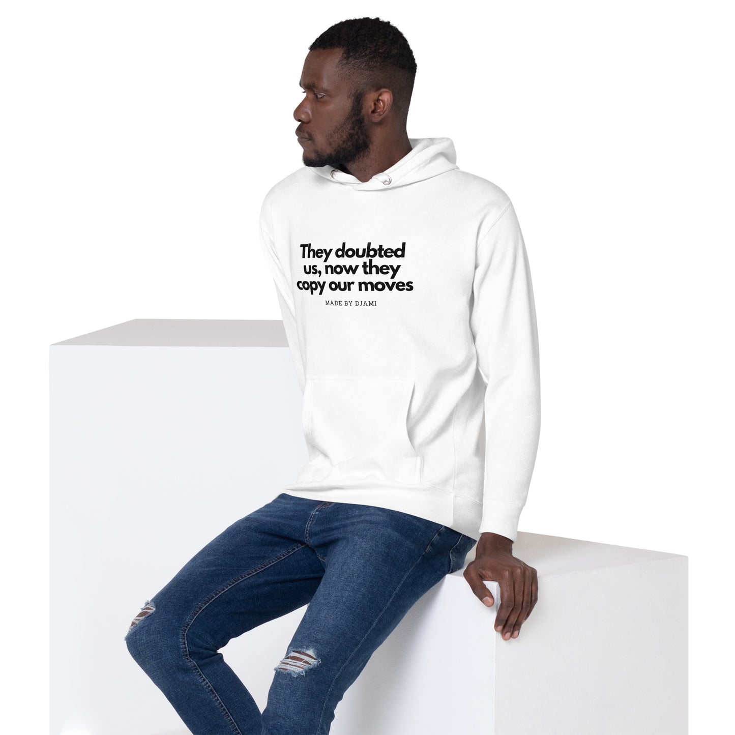 Product mockup of a White Hoodie with the text printed they doubted us, now they copy our moves