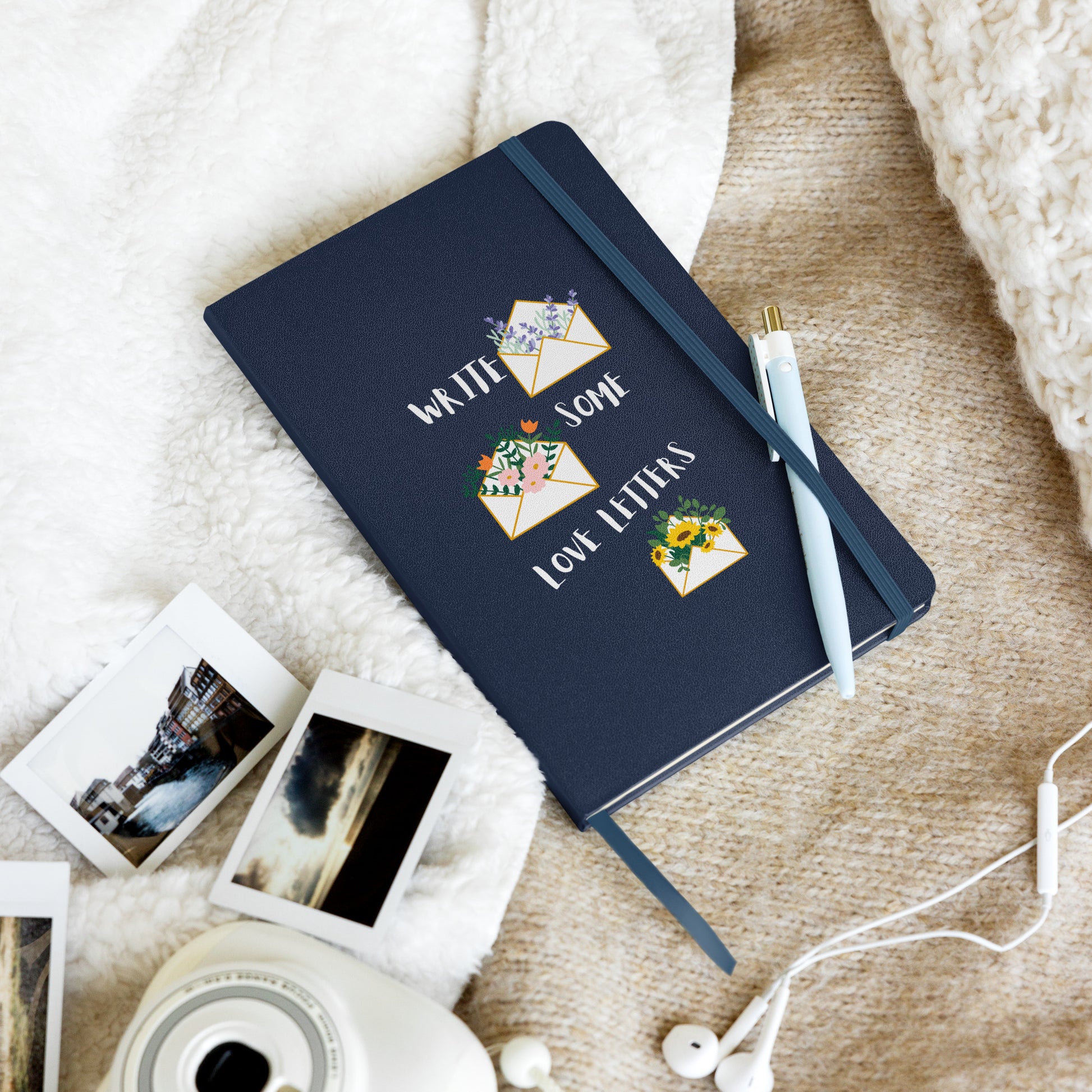 Navy blue notebook with illustrations of flower-filled envelopes and the text "Write Some Love Letters" on the cover.