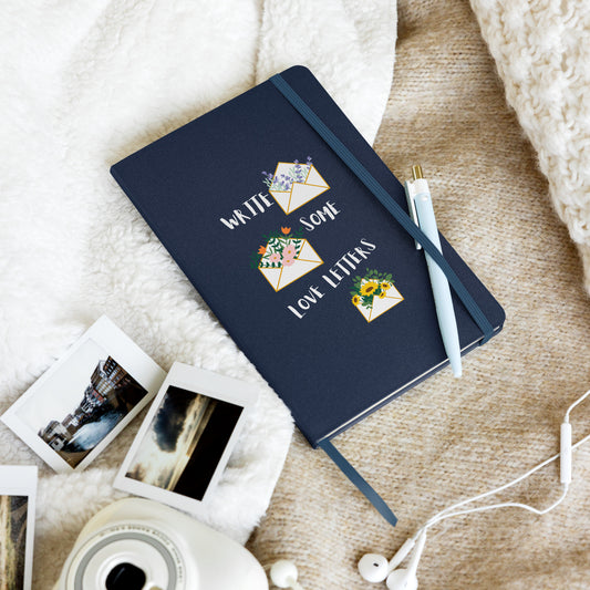 Navy blue notebook with illustrations of flower-filled envelopes and the text "Write Some Love Letters" on the cover.