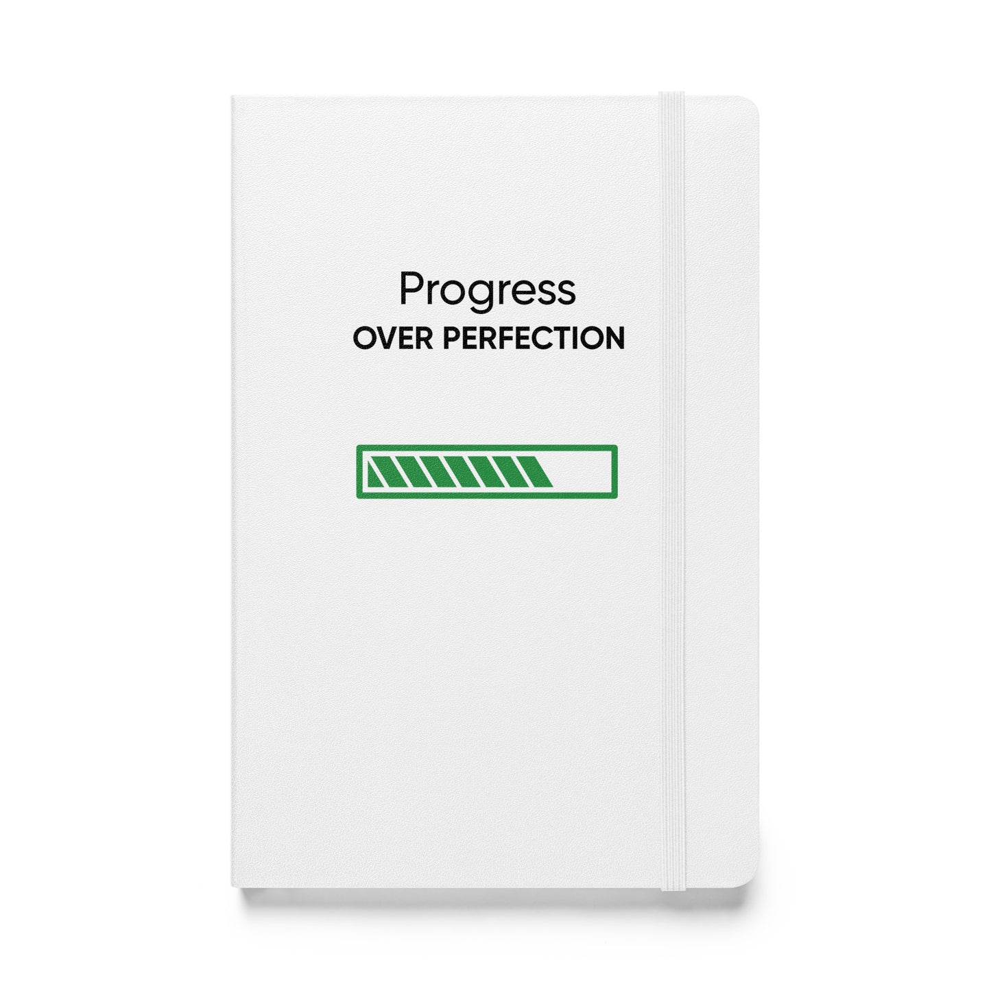 Weißes Notizbuch mit dem Text: „Progress over perfection“ und einem grünen Fortschrittsbalken.