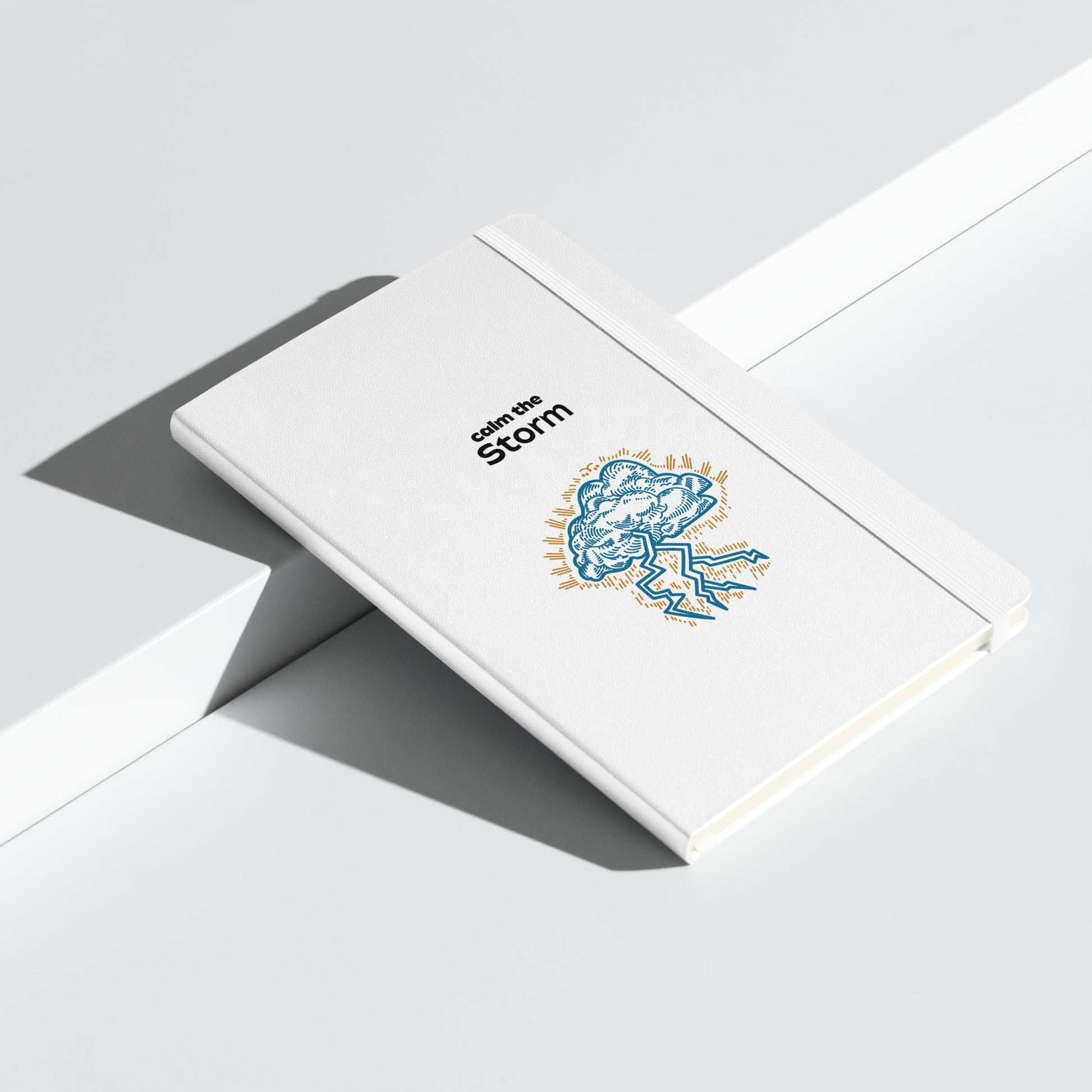 White notebook with "Calm the Storm" and an illustrated cloud with lightning.