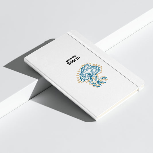 White notebook with "Calm the Storm" and an illustrated cloud with lightning.